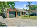 View of home showing brick exterior, garage, yard, and driveway at 9630 Crosscut Dr, Ladson, SC 29456
