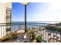 Relaxing outdoor balcony featuring a cozy seating area with lovely water views and potted plants at 1 King St # 501, Charleston, SC 29401