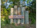 Rustic wooden sign that reads Towhee Lane, marking the entrance to the neighborhood at 1044 Towhee Ln, McClellanville, SC 29458