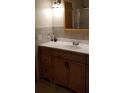 Bathroom vanity with white countertop and wood cabinets at 107 Kelly St, Walterboro, SC 29488
