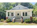 Charming white craftsman-style home with a welcoming front porch and manicured landscaping at 107 Tracy St, Walterboro, SC 29488