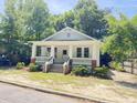 Charming white craftsman-style home with a welcoming front porch and manicured landscaping at 107 Tracy St, Walterboro, SC 29488