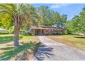 Traditional single-story home featuring brick exterior, red shutters, and mature landscaping at 1143 Winborn Dr, Charleston, SC 29412
