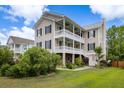Charming home with spacious porches, well-maintained lawn, and lush landscaping at 118 Wando Reach Rd, Wando, SC 29492