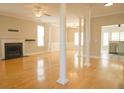Bright living room boasting a fireplace, hardwood floors, stylish columns, and open access to the kitchen at 120 Full Moon Ct, Ladson, SC 29456