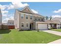 Attractive home with a manicured lawn and a two-car garage on a sunny day at 1311 Berry Grove Dr, Summerville, SC 29485