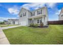 Beautifully landscaped front yard with lush green grass leading to a welcoming home and a neatly edged flower bed at 134 Lucca Dr, Summerville, SC 29486