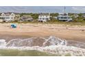 Beautiful beach scene showing the ocean and the homes along the shoreline at 1404 Palmetto Blvd, Edisto Beach, SC 29438