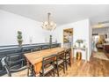 Dining room with a wood table, chandelier, and view to the kitchen and living areas at 1571 Blaze Ln, Charleston, SC 29412