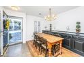Bright dining room with a wood table, elegant chandelier, and decorative display cabinet at 1571 Blaze Ln, Charleston, SC 29412
