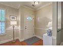 Bright and inviting foyer features elegant trim, hardwood floors, and decorative lighting at 1781 Brittlebush Ln, Johns Island, SC 29455