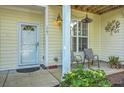 Welcoming front porch with comfortable seating, stylish lighting, and attractive landscaping at 1781 Brittlebush Ln, Johns Island, SC 29455