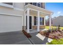 Covered front porch with craftsman columns and stone accents leads to the front door at 1816 Casein St, Summerville, SC 29483