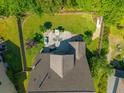 Aerial view of the backyard featuring a patio with outdoor seating and a fire pit, all enclosed by a wooden fence at 204 Black Gum Cir, Moncks Corner, SC 29461