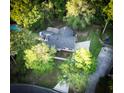 Aerial view of a house with a fenced yard, a wooden deck, a private pool, and mature trees in a suburban setting at 213 Factors Walk, Summerville, SC 29485