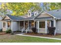 Inviting front porch with white railings and trim, complemented by large bay windows and well-maintained landscaping at 213 Factors Walk, Summerville, SC 29485