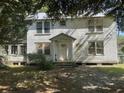 Charming two-story home featuring a covered porch, offering a welcoming curb appeal at 217 Scotia St, McClellanville, SC 29458