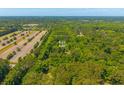 Aerial view of an expansive 5.03 acre property outlined in yellow, featuring lush trees and a grassy field at 2234 River Rd, Johns Island, SC 29455