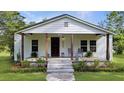 Inviting front porch with chairs, plants, and charming details at 224 Reeves St, Reevesville, SC 29471