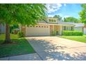 Cozy home featuring a lush, green lawn, a spacious two-car garage, and an inviting front entrance at 236 Everwood Ct, Moncks Corner, SC 29461