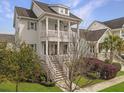 Two-story home featuring double porches and landscaped front yard at 2524 Josiah St, Charleston, SC 29492