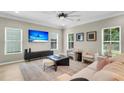 Comfortable living room featuring a ceiling fan, large windows, and contemporary furnishings at 3844 Annapolis Way, Ladson, SC 29456