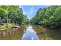 Lush waterfront with a private dock, offering serene water views and boating access amid lush greenery at 418 Lakeview Dr, Summerville, SC 29485