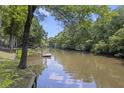 Peaceful waterfront with a private dock, framed by lush greenery and serene water views at 418 Lakeview Dr, Summerville, SC 29485