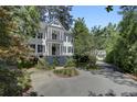 Two-story home featuring a double balcony, manicured landscaping, and circular driveway for curb appeal at 418 W Carolina Ave, Summerville, SC 29483