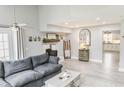 Bright and airy living room with a gray sofa, fireplace, and neutral decor at 49 Auld Brass Rd, Walterboro, SC 29488