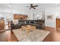 Cozy living room with plush sectional sofa, patterned rug, ceiling fan, and hardwood floors at 5022 W Liberty Meadows Dr, Summerville, SC 29485