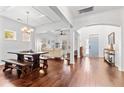 Open concept living area featuring hardwood floors, coffered ceiling, and an abundance of natural light at 5022 W Liberty Meadows Dr, Summerville, SC 29485