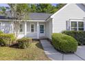Inviting home facade with a well-manicured lawn and mature landscaping at 527 Hainsworth Dr, Charleston, SC 29414