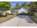 A well maintained property with a long driveway surrounded by lush greenery at 527 Hainsworth Dr, Charleston, SC 29414