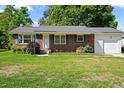 Charming single-story brick home with shutters, well-kept lawn, and attached single-car garage entrance at 5321 Trudy St, North Charleston, SC 29418