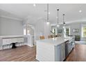 Open concept kitchen featuring an island with sink, hardwood floors, and stainless steel dishwasher at 539 Cooper Village Ln, Mount Pleasant, SC 29464