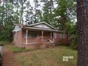 Charming brick home featuring a covered front porch, perfect for enjoying the outdoors at 604 King St, Walterboro, SC 29488