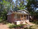 Charming brick home featuring a covered front porch, perfect for enjoying the outdoors at 604 King St, Walterboro, SC 29488