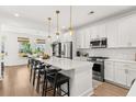 Spacious kitchen featuring a large island, modern appliances, and stylish pendant lighting at 619 Trio Ln, Summerville, SC 29486