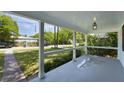Covered porch featuring white columns, painted floors, and views of the neighborhood at 81 Avondale Ave, Charleston, SC 29407