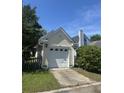 Detached one-car garage with white door and siding, nestled in a well-maintained yard with mature trees at 86 Cross Timbers Dr, Summerville, SC 29485