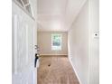 Inviting entryway with neutral paint, plush carpet, and natural light from the window at 1210 Azalea Dr, Summerville, SC 29483