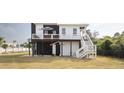Stylish home with a charming exterior, featuring an outdoor deck and well-manicured lawn at 126-C Jungle Rd, Edisto Beach, SC 29438