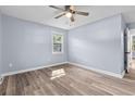 Bedroom with wood-look floors, neutral paint, and window with natural light at 1383 W Lenevar Dr, Charleston, SC 29407