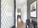 Welcoming foyer showcasing modern decor, hardwood floors, and an inviting view into the living space at 1441 Arabella St, Charleston, SC 29414