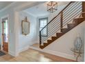 Bright entryway featuring a staircase with metal railings and light hardwood floors at 15 Dewey St, Charleston, SC 29403