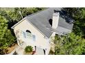 Aerial view of a tan, well maintained two-story home with a gray roof and mature landscaping at 1551 Ben Sawyer Blvd # 23, Mount Pleasant, SC 29464