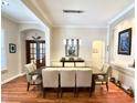 Well-lit dining room with dark wood table and seating for eight, featuring recessed wall niches at 1736 James Basford Pl, Mount Pleasant, SC 29466