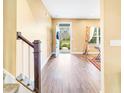 Inviting foyer with wood-look floors, staircase, and a view of the front door leading to a landscaped exterior at 204 Lynx Ln, Summerville, SC 29483