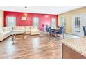 Open-concept living area with wood floors and access to outdoor patio at 204 Lynx Ln, Summerville, SC 29483